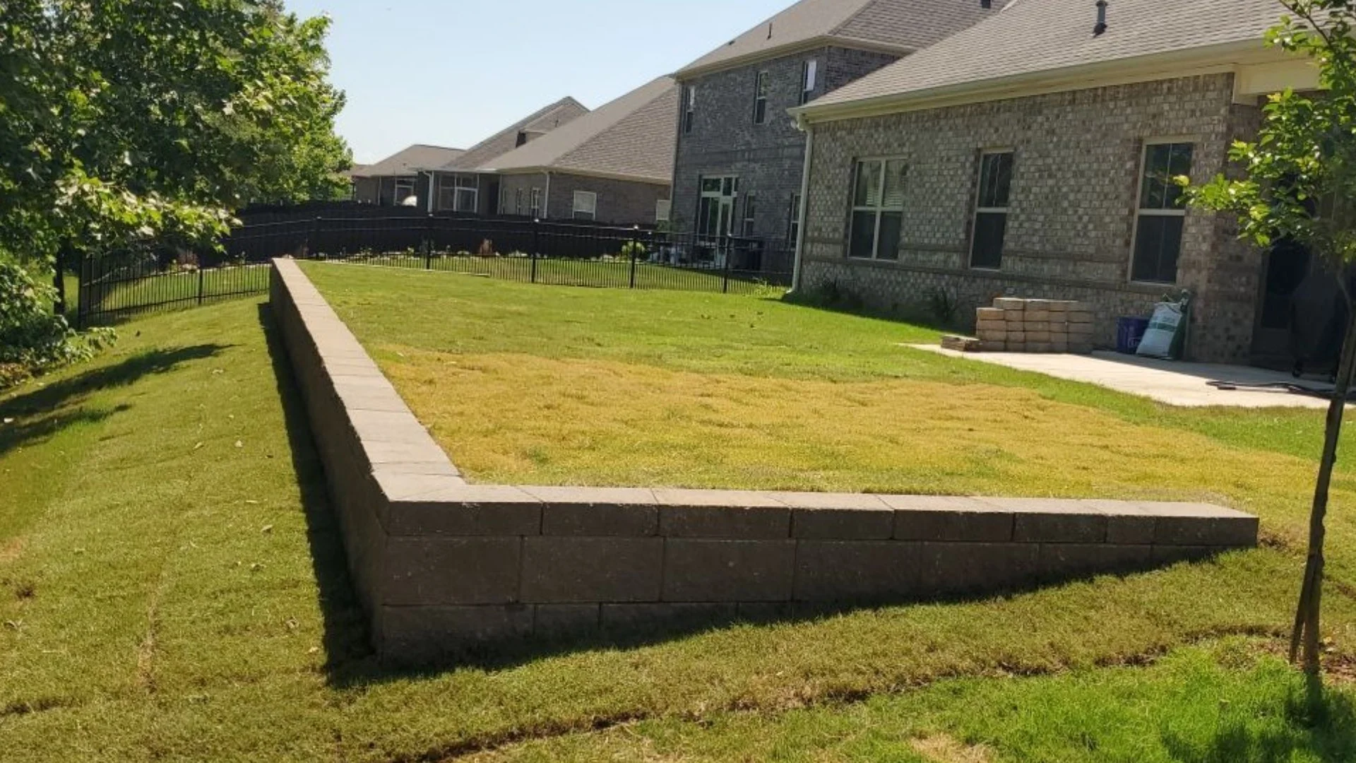 How Do Retaining Walls Help Address Issues With Sloped Yards?