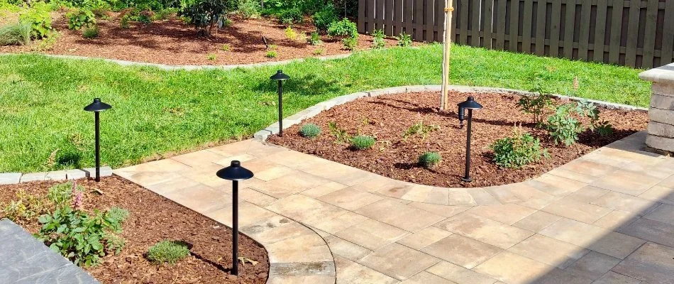 Landscape beds in Huntsville, AL, with plants and mulch.