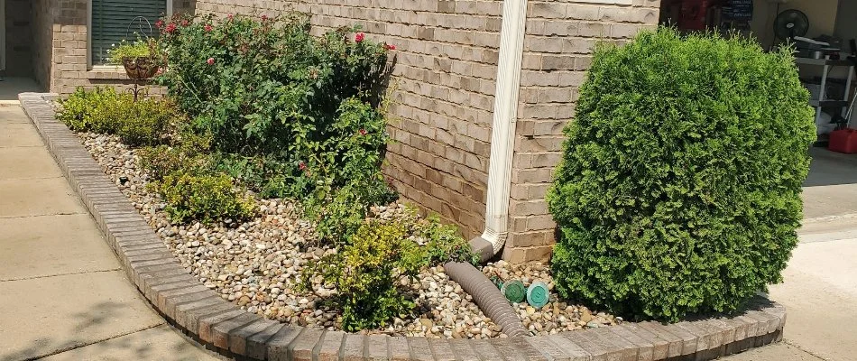Landscaping area in Huntsville, AL, with rocks and shrubs.