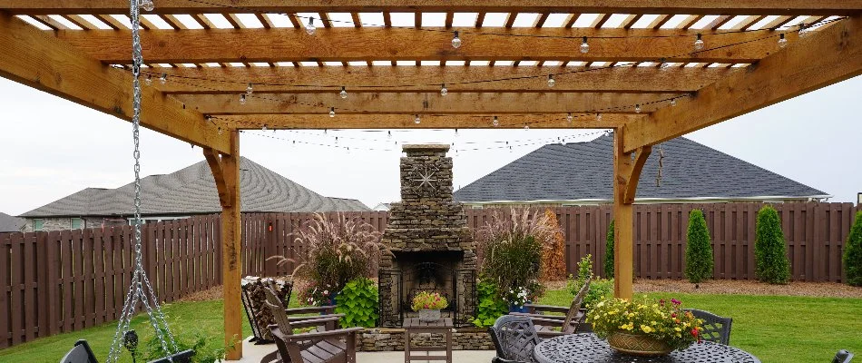 Outdoor fireplace under a pergola in Huntsville, AL.
