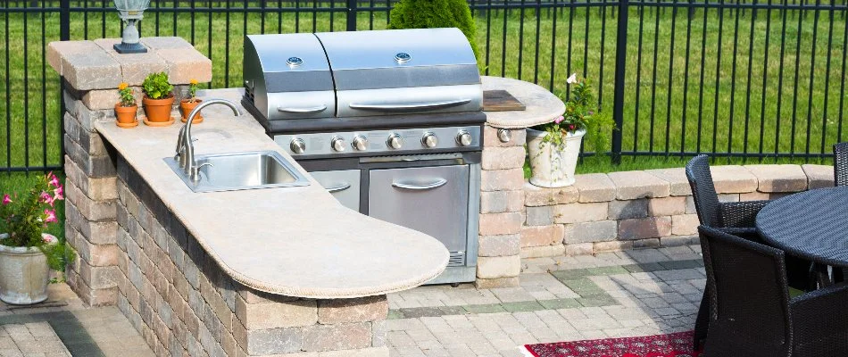 Outdoor kitchen in Huntsville, AL, with a grill and sink.