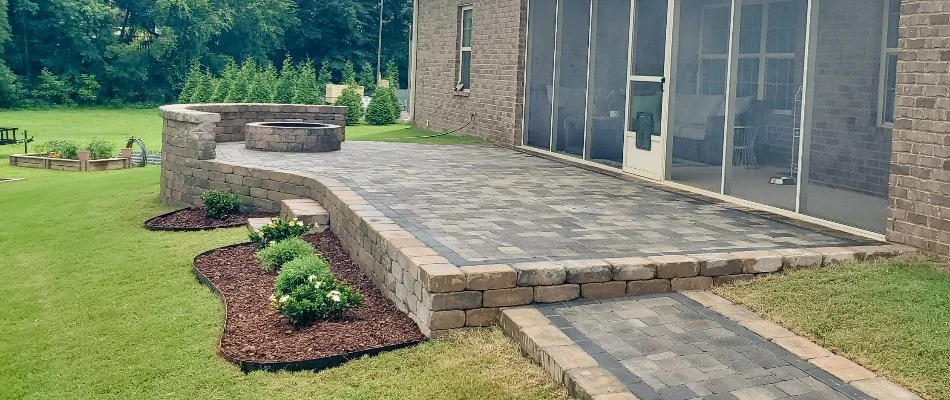 Retaining wall in Huntsville, AL, with a patio, fire pit, and seating wall.