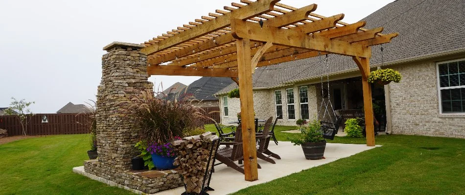 Patio in Huntsville, AL, with outdoor fireplace and pergola.
