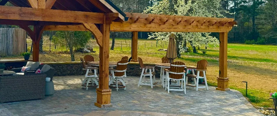 Patio with chairs in Huntsville, AL, under a wooden pergola.
