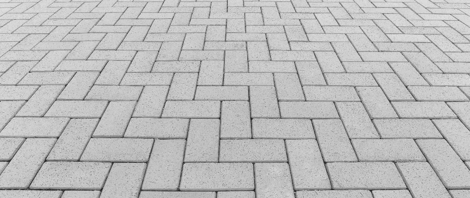 Patio in Huntsville, AL, with a herringbone paver pattern.