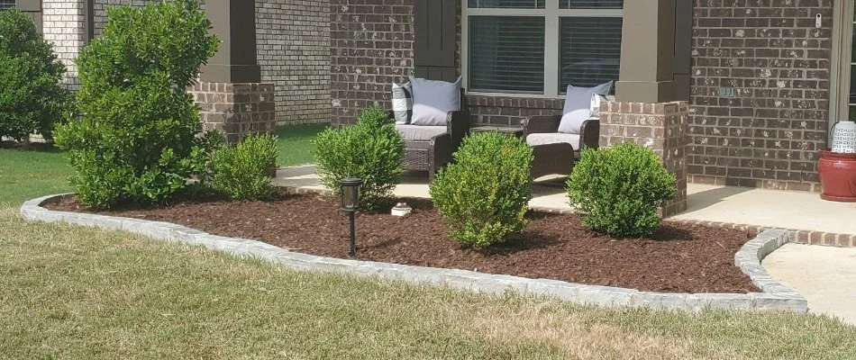 Landscape bed in Huntsville, AL, with plants and mulch.