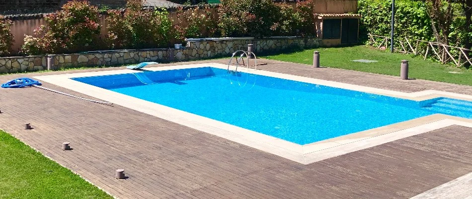 Wood decking around a rectangular pool in Huntsville, AL.