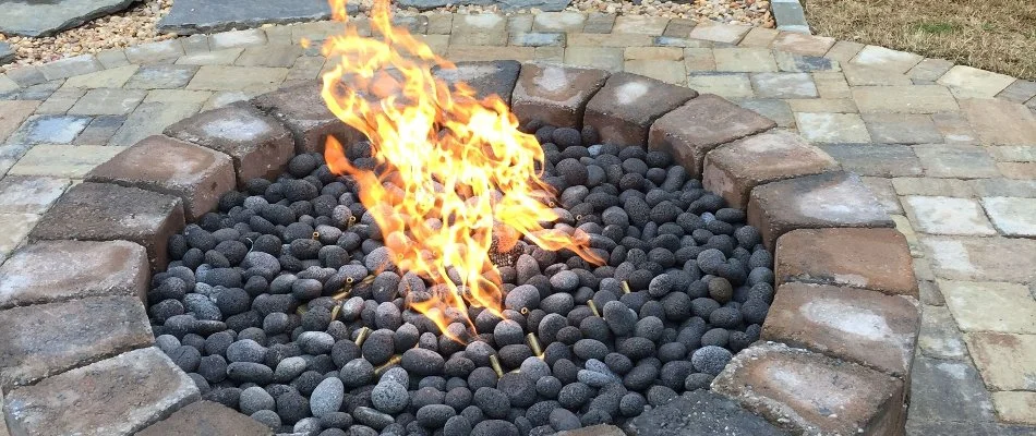 Fire pit with flames on a property in Huntsville, AL.