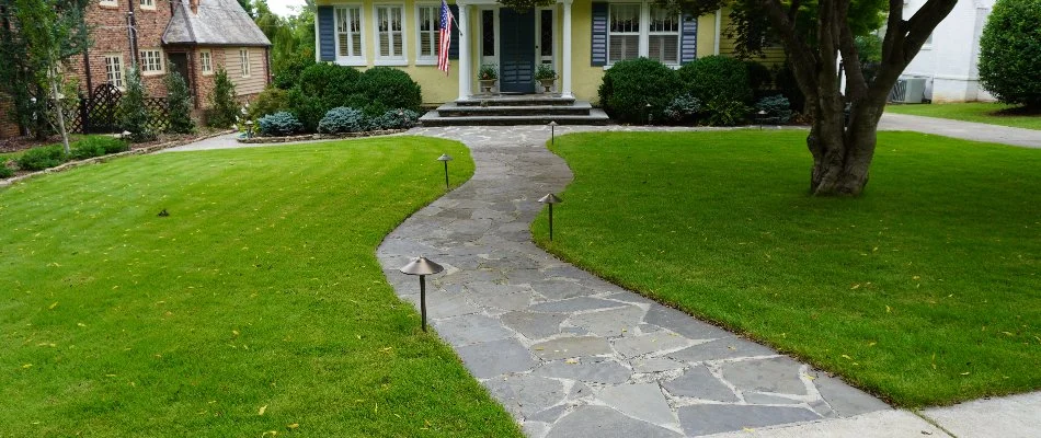 Green grass along a walkway to a house in Estill Springs, TN.