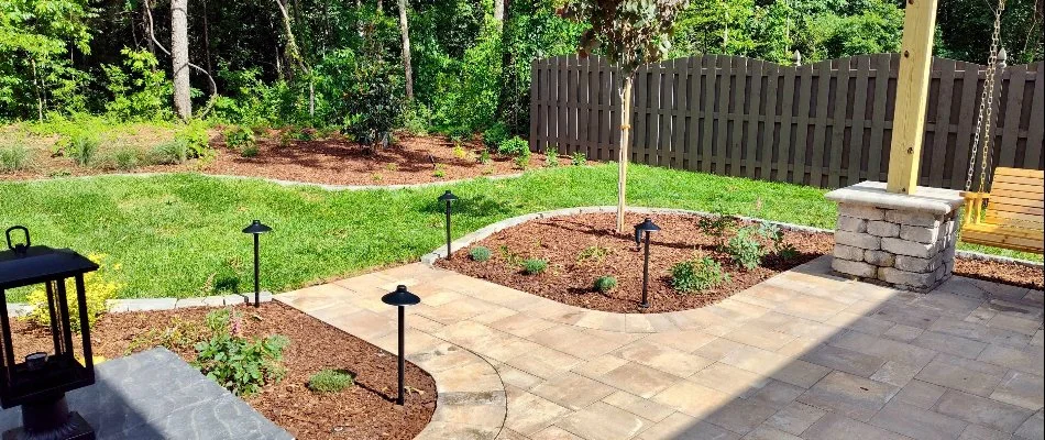 Mulched landscape bed in Maysville, AL, with plants and flowers.