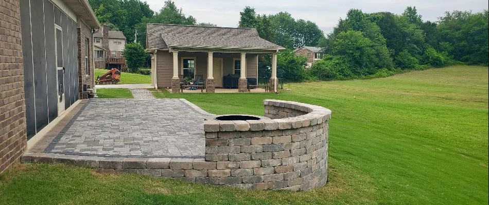 Patio area with fire pit and seating wall in Olde Cobblestone, AL.