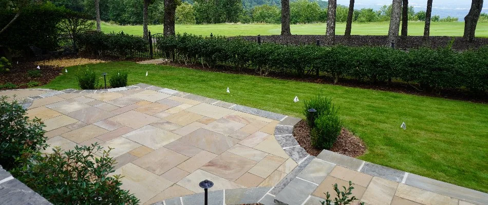Patio in yard with nice landscaping on a property in Huntsville, AL.