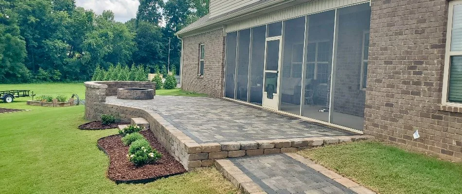 Paver patio in Estill Springs, TN, with a retaining wall and fire pit.