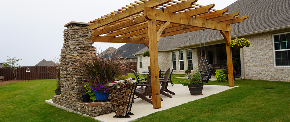 A pergola and fireplace installed in a backyard in Winchester, TN.