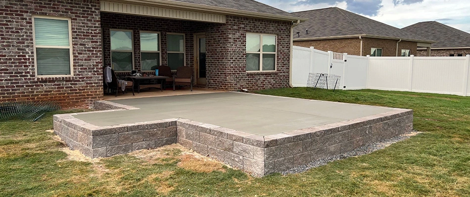 Retaining wall installed beside raised patio in Hazel Green, AL.