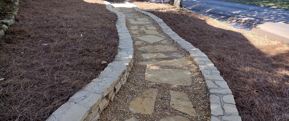 Walkway and retaining wall installed in a landscape in Huntsville, AL.