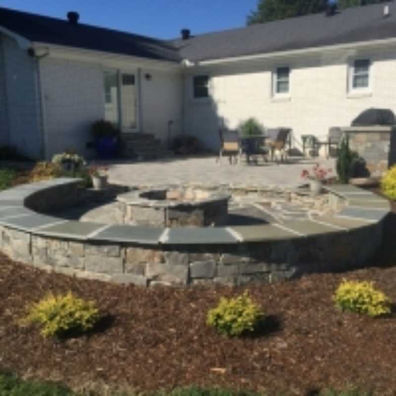 Paver Patio With A Grill Station, Bubbling Rock, Sitting Wall, And Fire Pit In Fayetteville, TN